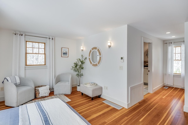 living area featuring wood finished floors, baseboards, and recessed lighting