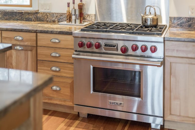 kitchen with premium stove and wood finished floors