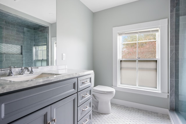 bathroom with toilet, an enclosed shower, and vanity