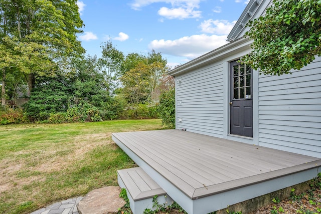 wooden deck featuring a yard