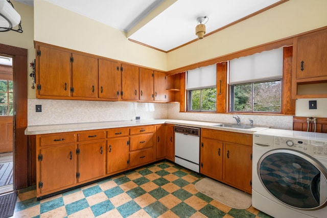 kitchen featuring sink, washer / clothes dryer, and white dishwasher