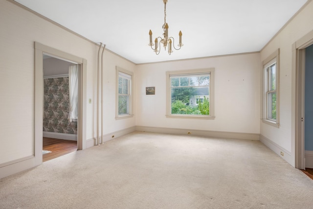 unfurnished dining area featuring an inviting chandelier, crown molding, and light carpet