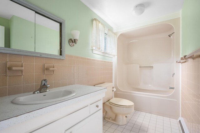 full bathroom featuring shower / bath combination, tile walls, baseboard heating, tile patterned floors, and vanity