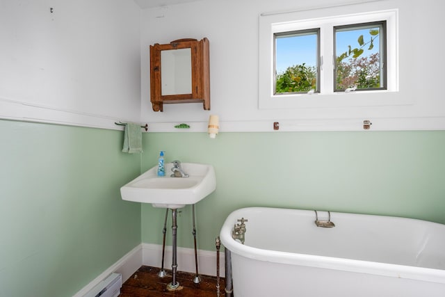 bathroom featuring sink and a bath