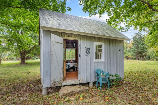 view of outbuilding featuring a lawn