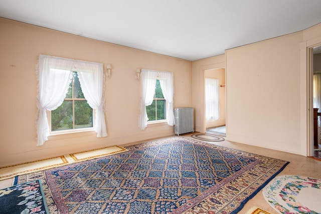 empty room with a healthy amount of sunlight and radiator