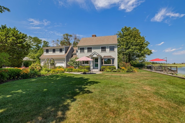 7 Sunrise Ln, Sandwich, MA 02563 - view of front facade featuring a chimney, a front yard, and a water view