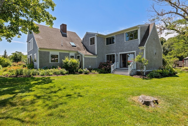 7 Sunrise Ln, Sandwich, MA 02563 - rear view of property featuring a chimney, roof with shingles, and a yard