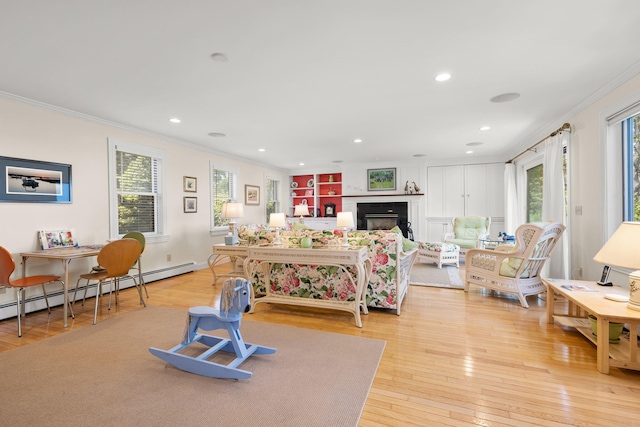 7 Sunrise Ln, Sandwich, MA 02563 - living room with ornamental molding, plenty of natural light, light wood finished floors, a fireplace, and recessed lighting