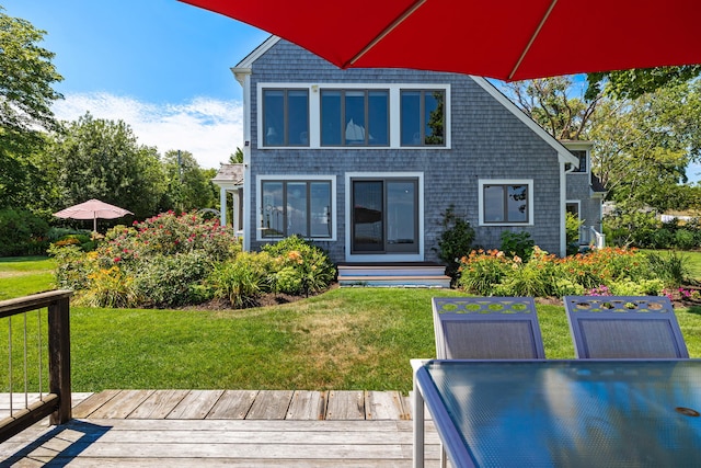 7 Sunrise Ln, Sandwich, MA 02563 - back of property featuring a deck, outdoor dining space, a lawn, and entry steps