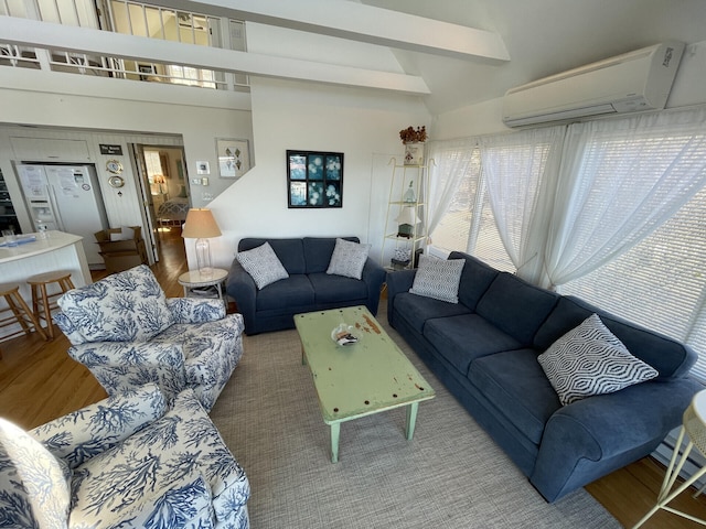 living room featuring beamed ceiling, an AC wall unit, high vaulted ceiling, and wood-type flooring