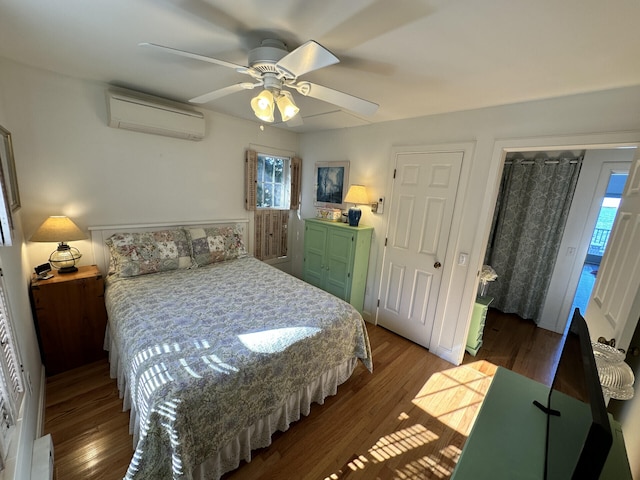 bedroom with hardwood / wood-style floors, a closet, an AC wall unit, and ceiling fan