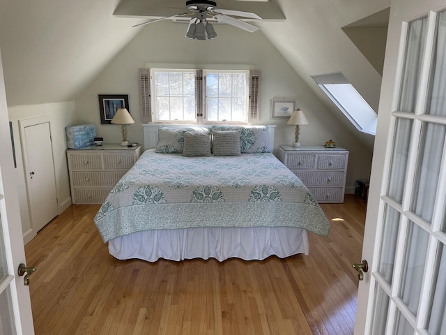 bedroom featuring ceiling fan, light hardwood / wood-style flooring, and vaulted ceiling