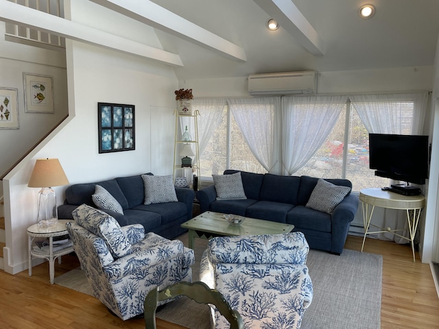 living room with hardwood / wood-style flooring, plenty of natural light, a wall mounted air conditioner, and beam ceiling