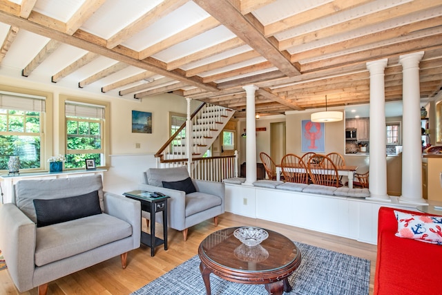 351A Commercial St Unit A1, Provincetown, MA 02657 - living room featuring ornate columns, light wood finished floors, stairway, and beamed ceiling
