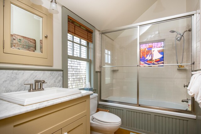 351A Commercial St Unit A1, Provincetown, MA 02657 - full bathroom with vanity, combined bath / shower with glass door, lofted ceiling, and decorative backsplash
