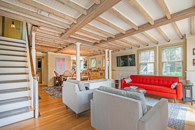 351A Commercial St Unit A1, Provincetown, MA 02657 - living area with decorative columns, stairs, light wood finished floors, and beam ceiling