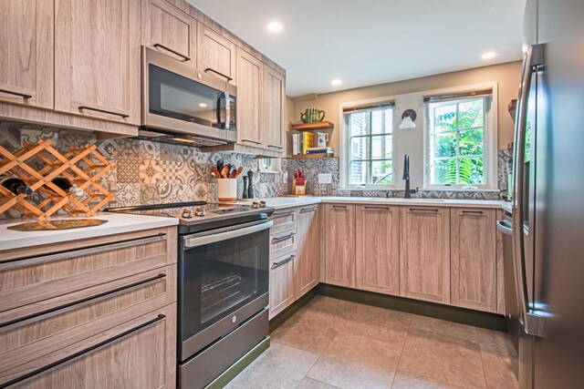 351A Commercial St Unit A1, Provincetown, MA 02657 - kitchen featuring appliances with stainless steel finishes, light brown cabinets, tasteful backsplash, light countertops, and recessed lighting