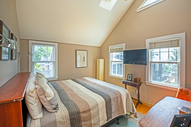 351A Commercial St Unit A1, Provincetown, MA 02657 - bedroom featuring a skylight, wood finished floors, and vaulted ceiling