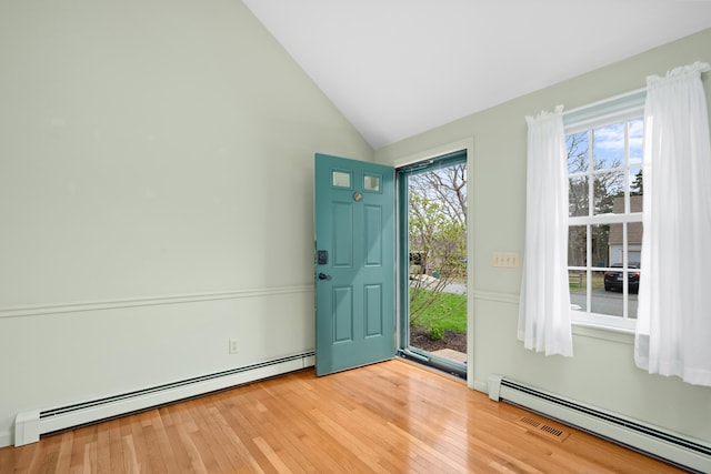 60 Covey Dr, Yarmouth Port, MA 02675 - doorway featuring baseboard heating, lofted ceiling, and light wood-type flooring
