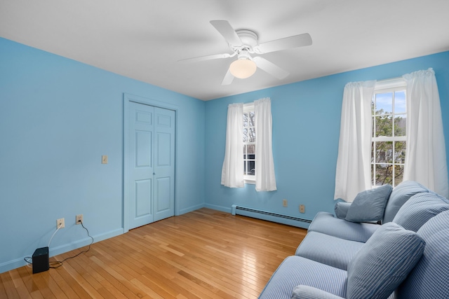 60 Covey Dr, Yarmouth Port, MA 02675 - sitting room featuring light wood-type flooring, baseboards, ceiling fan, and a baseboard heating unit