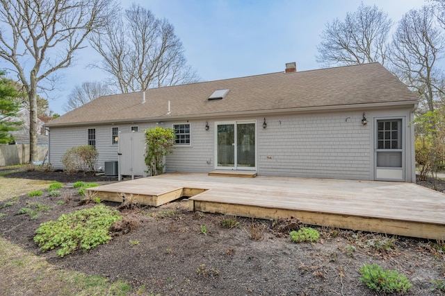 60 Covey Dr, Yarmouth Port, MA 02675 - rear view of property with central air condition unit, a wooden deck, a chimney, and roof with shingles