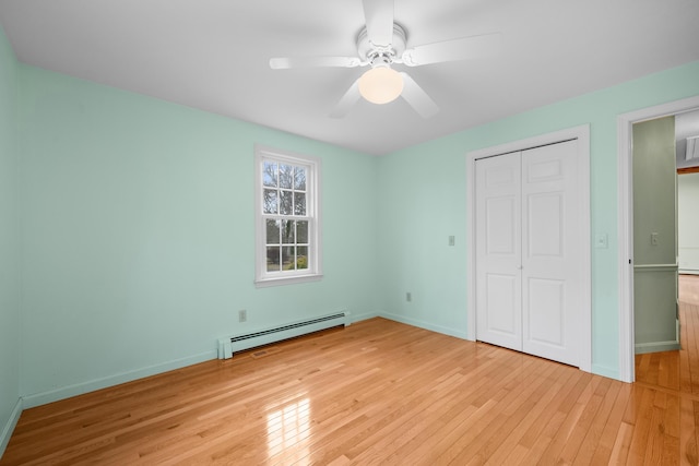 60 Covey Dr, Yarmouth Port, MA 02675 - unfurnished bedroom featuring a closet, baseboards, a baseboard heating unit, and light wood finished floors