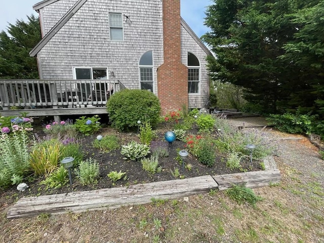 back of property with a deck and a chimney