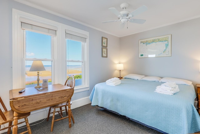 bedroom with crown molding, dark carpet, and ceiling fan