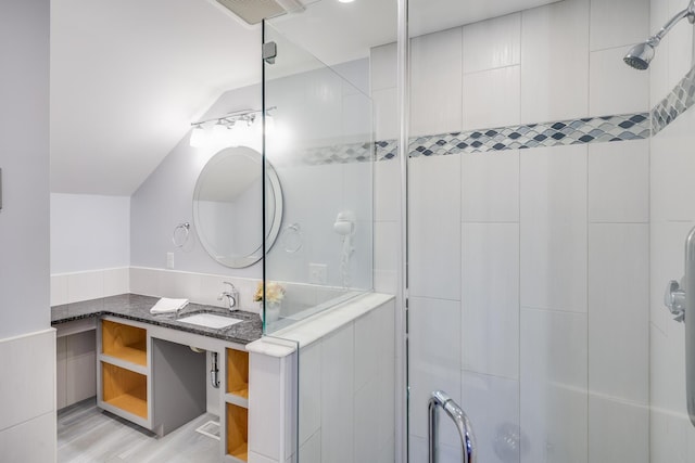 bathroom featuring vanity, vaulted ceiling, an enclosed shower, and hardwood / wood-style flooring