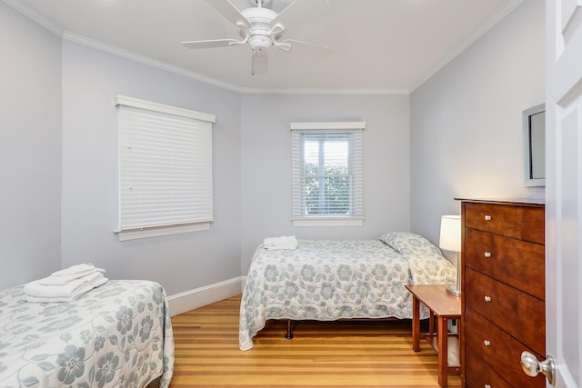 bedroom featuring ceiling fan, light hardwood / wood-style floors, and ornamental molding