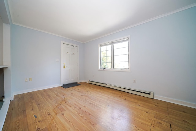 interior space featuring a baseboard heating unit, baseboards, ornamental molding, and light wood finished floors