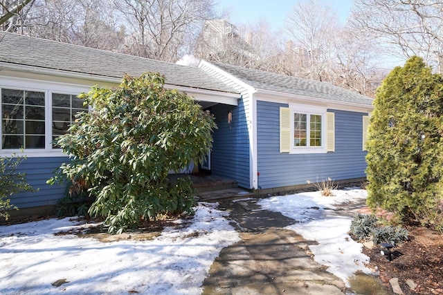 exterior space with roof with shingles