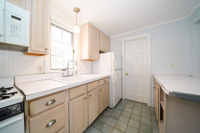 kitchen with ornamental molding, white appliances, light countertops, and a sink