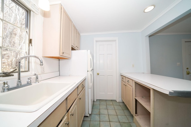 kitchen featuring ornamental molding, light countertops, cream cabinetry, a sink, and light tile patterned flooring