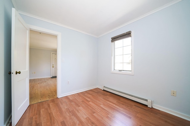 unfurnished room featuring light wood-style floors, baseboards, ornamental molding, and baseboard heating