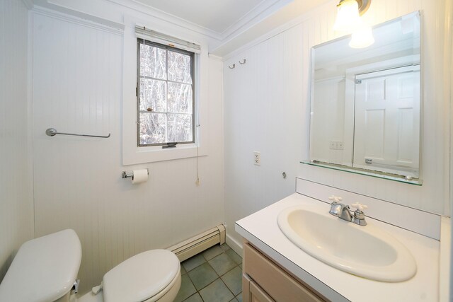 bathroom featuring crown molding, toilet, a baseboard heating unit, vanity, and tile patterned floors