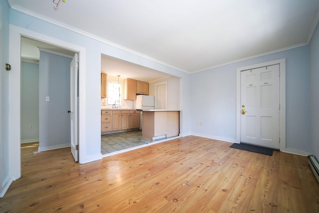 unfurnished living room with light wood-type flooring, crown molding, and baseboards