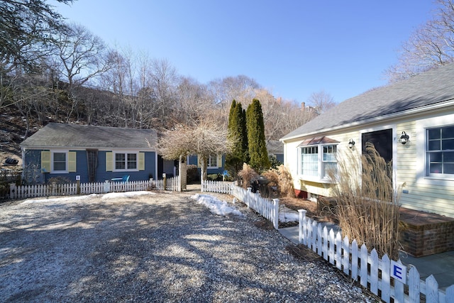 single story home featuring driveway and a fenced front yard