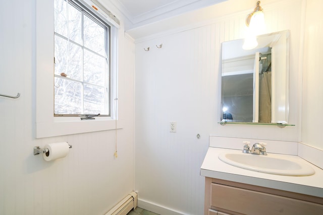 bathroom with a healthy amount of sunlight, crown molding, and vanity