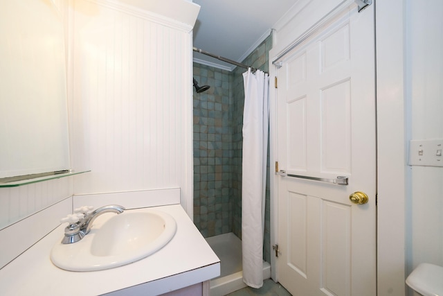 bathroom with a shower stall and vanity