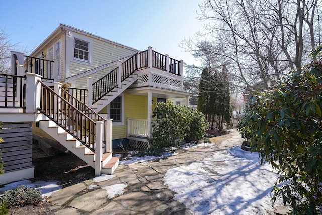 view of side of home featuring stairway