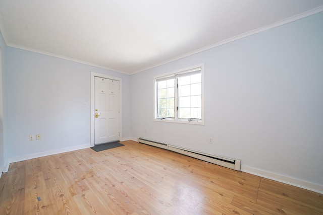 unfurnished room with ornamental molding, baseboard heating, wood finished floors, and baseboards