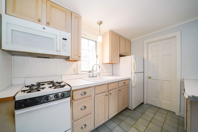 kitchen with white appliances, light brown cabinets, light countertops, and a sink