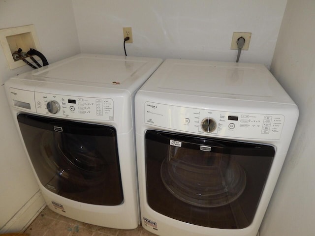 laundry room with washing machine and clothes dryer and laundry area
