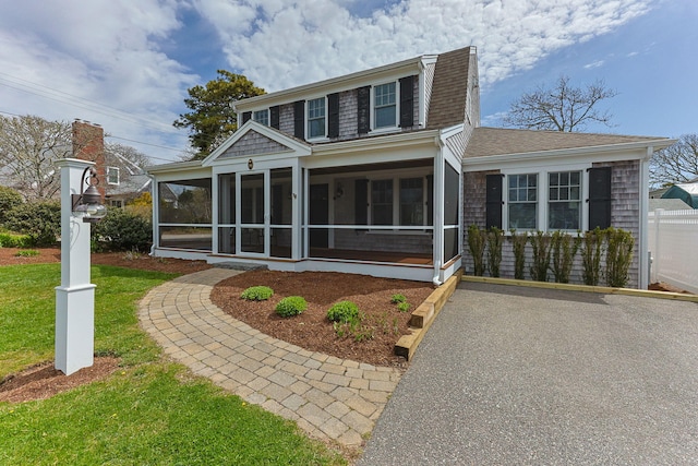 29 Hiawatha Rd, Harwich Port, MA 02646 - back of property with a yard, roof with shingles, and a sunroom