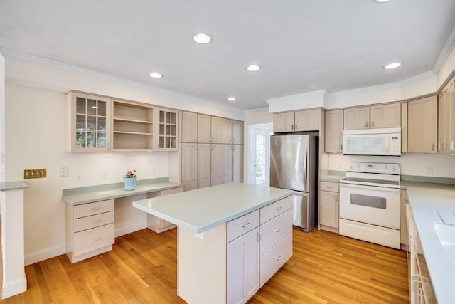 kitchen with white appliances, ornamental molding, and a center island