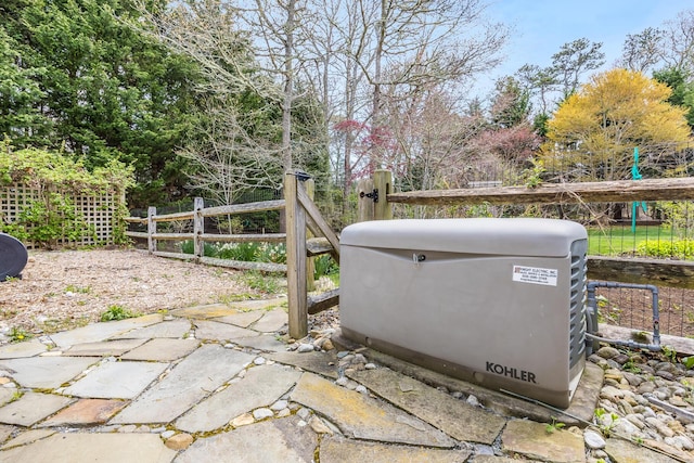 exterior details featuring fence and a power unit