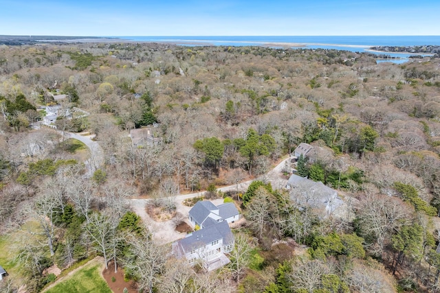 birds eye view of property with a view of trees and a water view