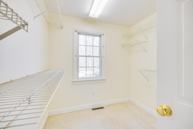 spacious closet featuring visible vents